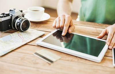 Young man planning a trip online with digital tablet